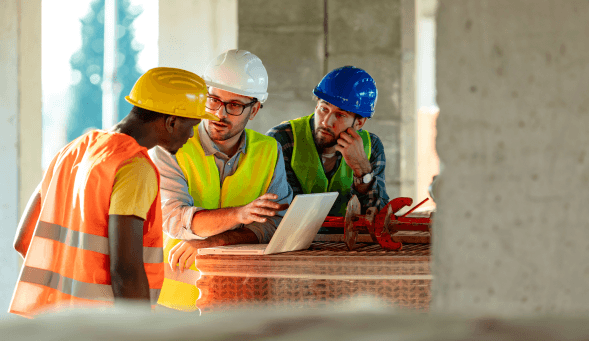 Construction workers reviewing safety processes