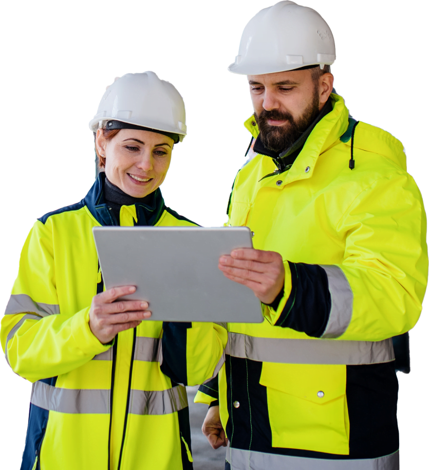 Construction workers in hardhats and green high vision jackets