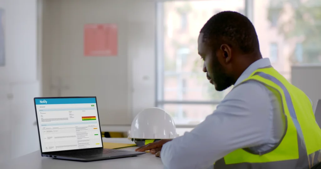 Health and safety worker using a laptop