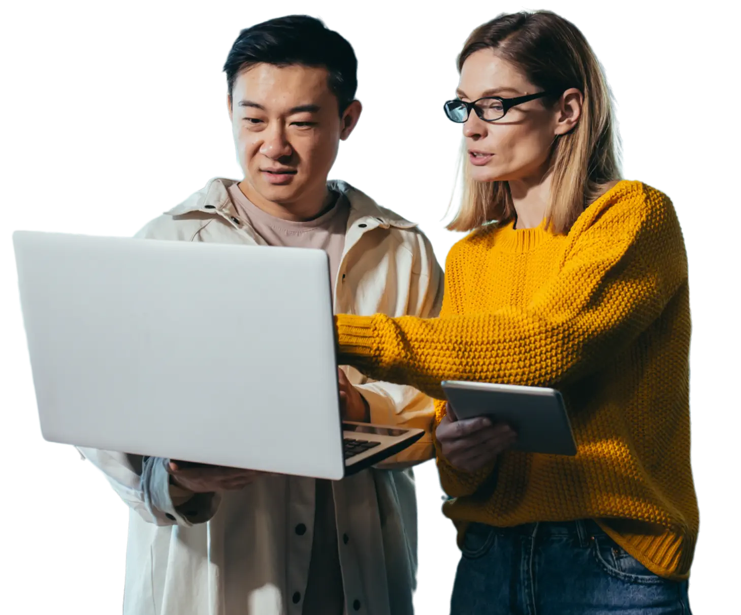 Man holding a laptop with woman holding a tablet