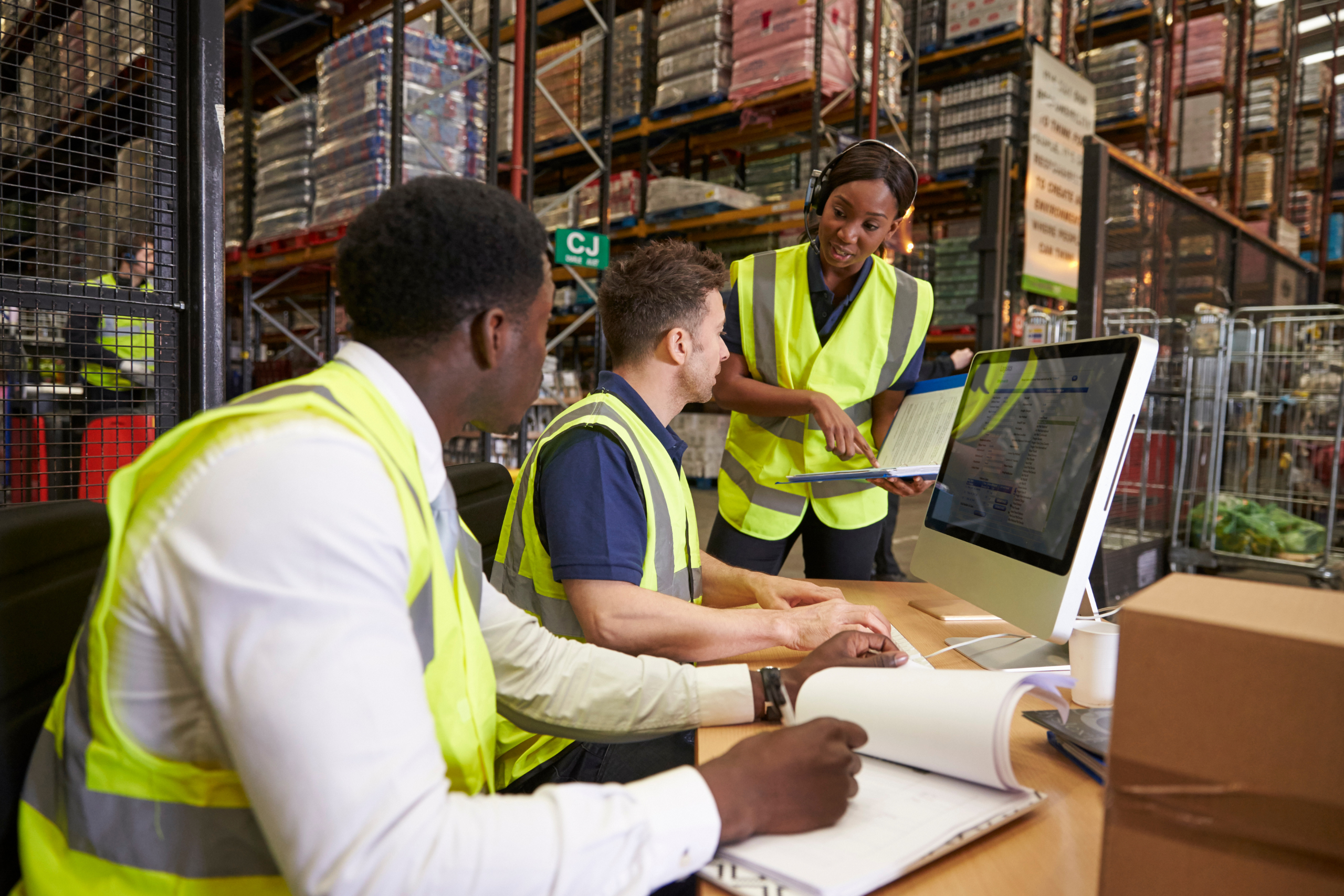 Colleagues discussing information on a clipboard